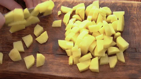 Human hands cut raw potatoes into slices. Stock Footage 251648959