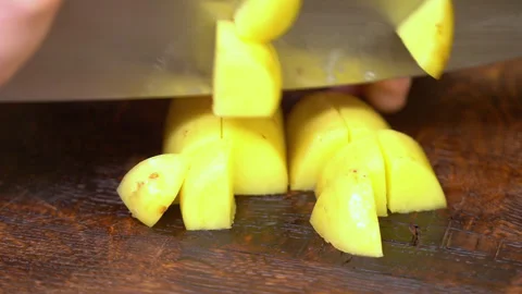 Human hands cut raw potatoes into slices. Stock Footage 253717656
