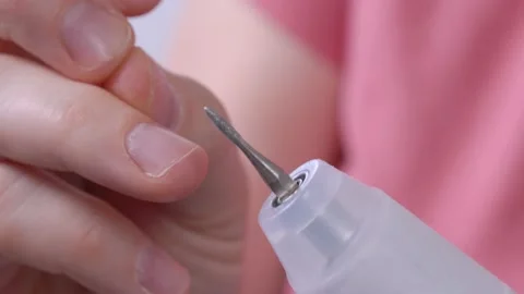 Human hands with electronic appliance for cuticle removing Stock Footage 131851815