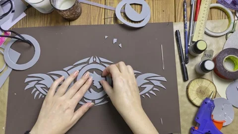 Human hands glue details of pattern to sheet of eva foam. Stock Footage 163076059