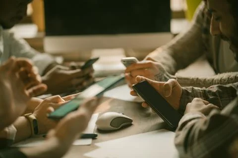 Human Hands Of Group Typing On Mobile Phones Stock Photos