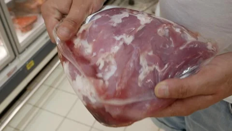 Human hands holding, customer choosing red meat t in a butcher's shop for delici Stock Footage 279008453