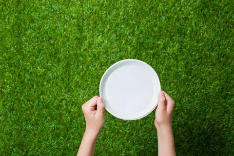 Human hands holding empty dish Stock Photos