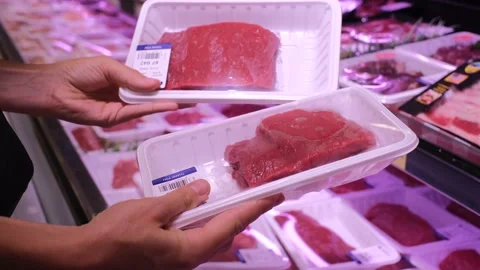 Human hands holding packaged fresh meat fillets, choosing beef for cooking in Stock Footage 166986705