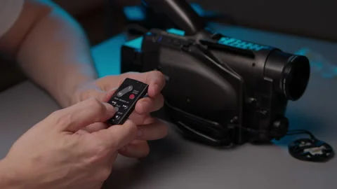 Human hands holding small remote control and replacing dead coin cell battery to Stock Footage 342763836