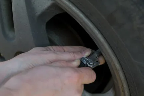 Human hands insert the hose of the car pump Stock Photos