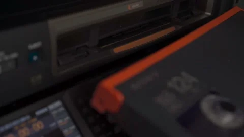 Human Hands inserting videotape sony hdcam vtr Close up Video stock 237551333