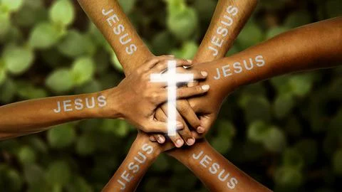 Human hands with Jesus text joined together and centered with a glowing Chr.. Photos