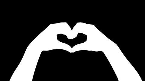 Human hands making heart gesture with fingers on black background. 스톡 동영상 335694318