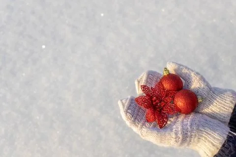 Human hands with open palms in white knitted mittens holding decorative new y Stock Photos