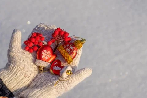 Human hands with open palms in white knitted mittens holding decorative new y Stock Photos