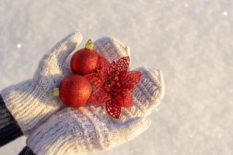 Human hands with open palms in white knitted mittens holding decorative new y Stock Photos