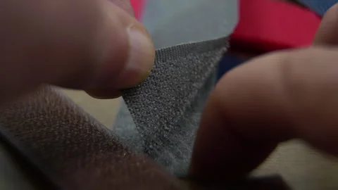 Human hands opening Velcro strap: working principle of Velcro fastener in action Stock Footage 318356450