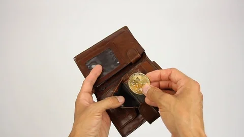 Human hands opens leather wallet and puts golden coin bitcoin, white background Stockbeeldmateriaal 92371058