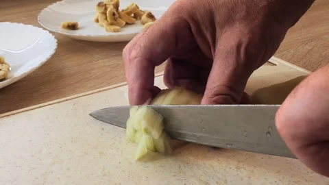 Human hands peel a pear and cut it with a knife on a cutting board 動画素材 317194602