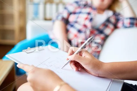 Human hands with pen making totes on paper in clipboard Stock Photos
