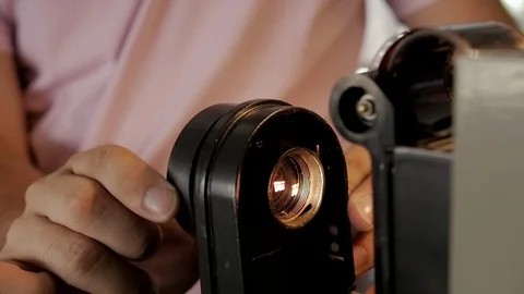 Human hands prepare the device for viewing and developing the film filmstrip Stock-Footage 111517522