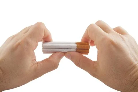 Human hands preparing to break stack of cigarettes Stock Photos