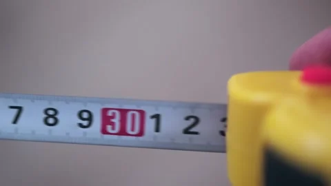 Human hands pull measuring tape out of tape measure, close up. Stock Footage 246519900