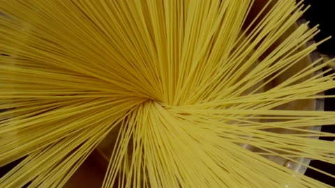 Human hands put down a spaghetti in a steel pot (round), Top view Видео 148467994