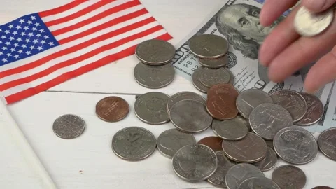 Human hands put one hundred dollar bills on table and pours out pile of coins Stock Footage