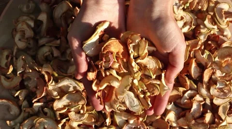 Human hands put sliced dried apples on the table, top view Stockbeeldmateriaal 54399744