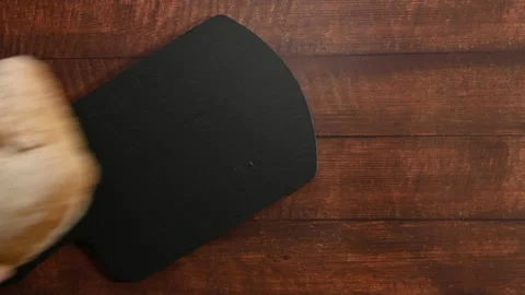 Human hands putting a homemade bread on a slate cutting board.  Stock Footage 196593938