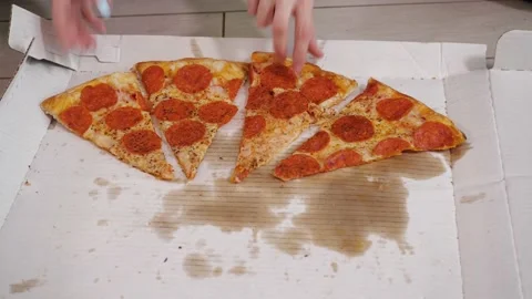 Human hands quickly take pieces of mouthwatering pizza from a white box Stock Footage 153419078