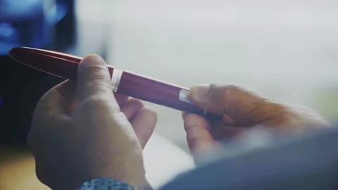 Human hands that regulate the operation of a red medical device-pens. Stock Footage 337711309