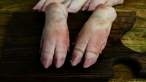 Human hands in rubber gloves funny banging with pork hooves. Stock Footage 129508291