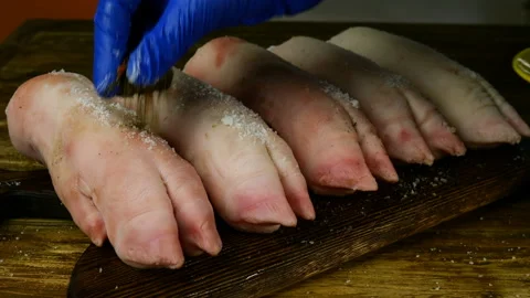 Human hands in rubber gloves sprinkle and rub with salt and pepper. Stock Footage 129507766