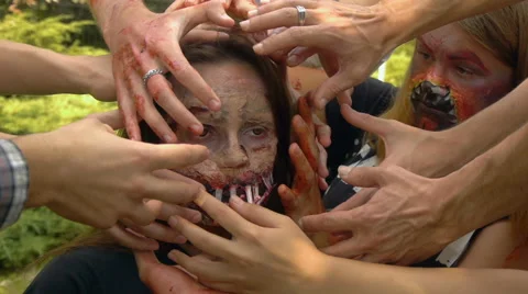 Human hands solidify near the zombies face with sad eyes, halloween Stock Footage 68208736