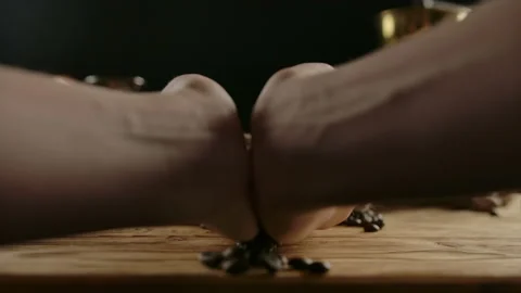 Human hands spread handfuls of dark roasted coffee beans from lying jute bag. Stock Footage 140365307