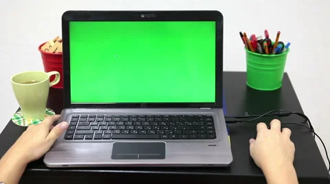 Human hands on table with green screen laptop, computer mouse moving Stock Footage