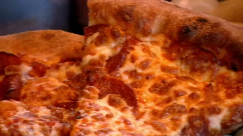 Human hands take slices of fresh pizza from an open box. Friends enjoy food in a Vídeos de archivo 336586719