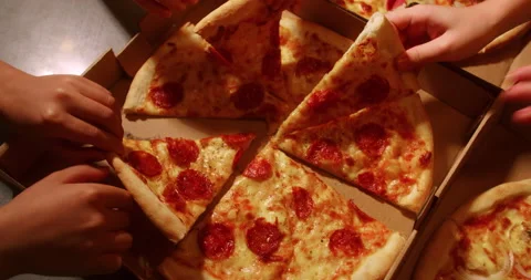 Human hands take slices of hot tasty italian pizza from open box, party food Stock Footage 217092138
