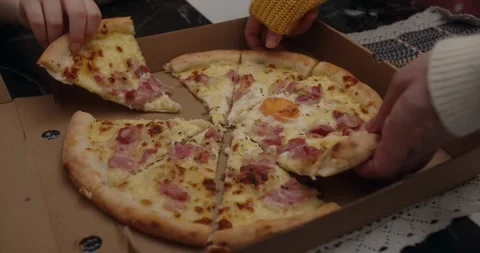 Human hands take slices of hot tasty italian pizza from open box, party food Stock Footage 313433244
