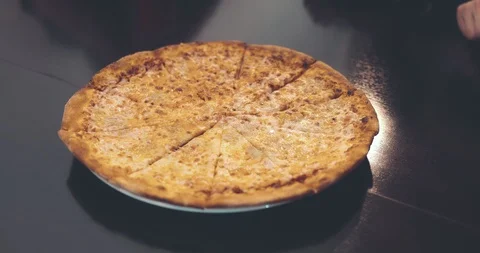 Human hands, taking bits and pieces of delicious pizza from a plate. Close-up Stock Footage 88688179