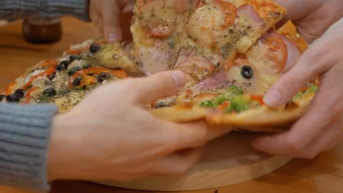 Human hands taking pieces slices of hot tasty italian pizza, close up view Stock Footage 99690286