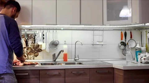 Human hands use a knife to cut meat. a man cuts up fresh meat for dinner in the  Video stock 144489032