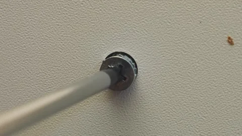 Human hands use a screwdriver to screw bolts into furniture with drawers. T.. 動画素材 333474227