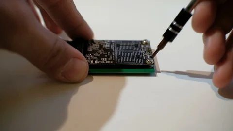 Human hands working on ssd chipset computer components with screwdriver,4k Stock Footage 118020966