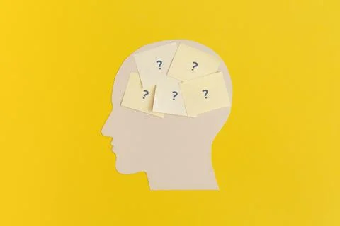 Human head with sticky notes on yellow background Fotos de archivo