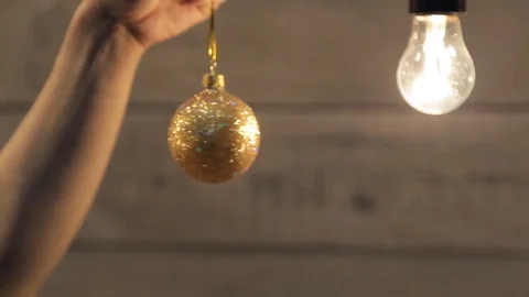 Human in his hand quickly turns on the tape shining yellow ball Video stock 71417029