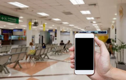Human holding blank screen of smart phone and waiting arrivals time backgro.. Stock Photos