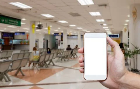Human holding blank screen of smart phone and waiting arrivals time backgro.. Stock Photos