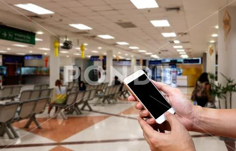 Human holding blank screen of smart phone and waiting arrivals time backgro.. Stock Photos