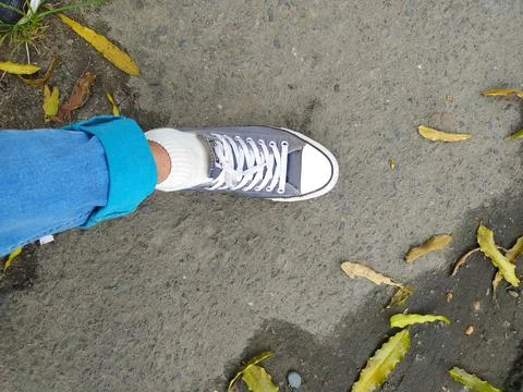Human leg on the left with blue pants, white socks 스톡 사진