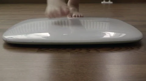 Human legs get in the electronic scale located on the floor and measure your Stock Footage 62407026