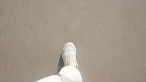 Human legs walk down the street, first person view from above. Walking outdoors. Stock Footage 270955419